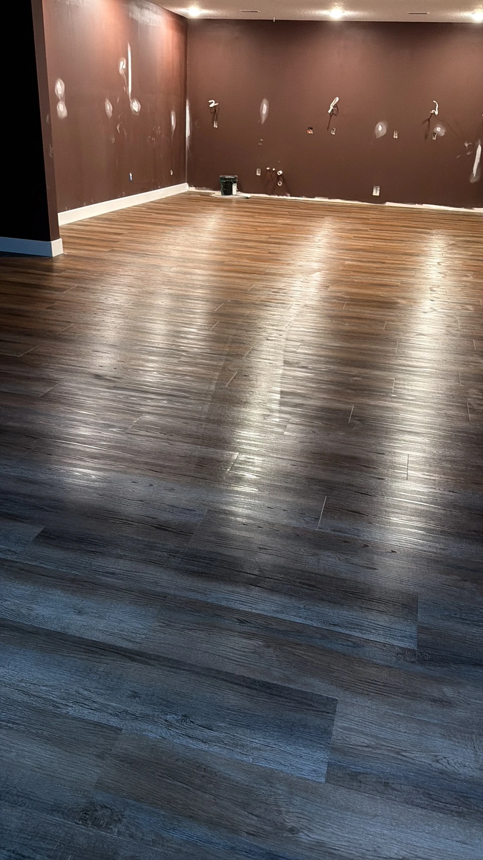 Wood-look flooring in a room with unfinished walls