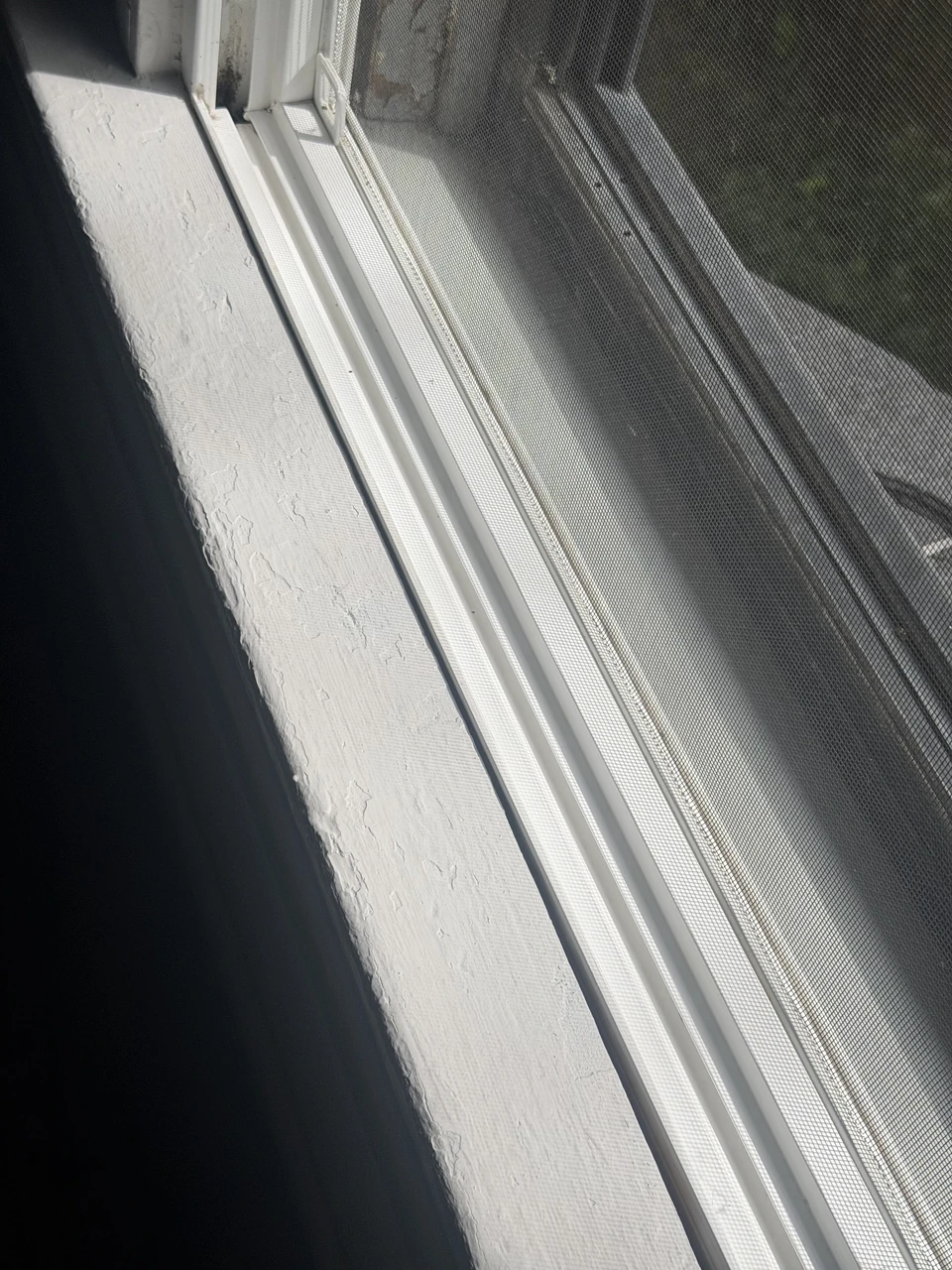 A close view of a window frame and track